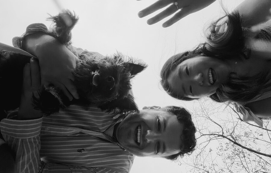 A playful selfie of Joy and Michael and their dog, taken from below